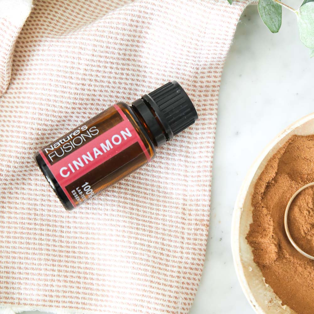 cinnamon essential oil with bowl of grounds