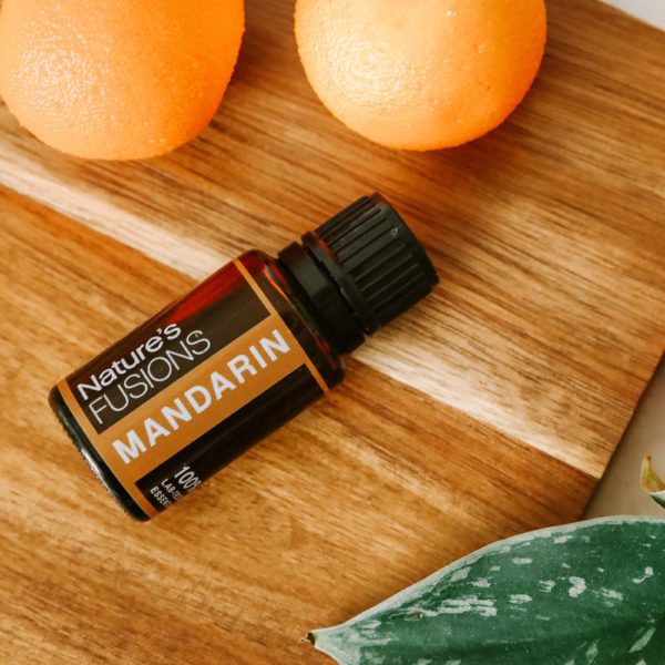 mandarin essential oil on counter with citrus