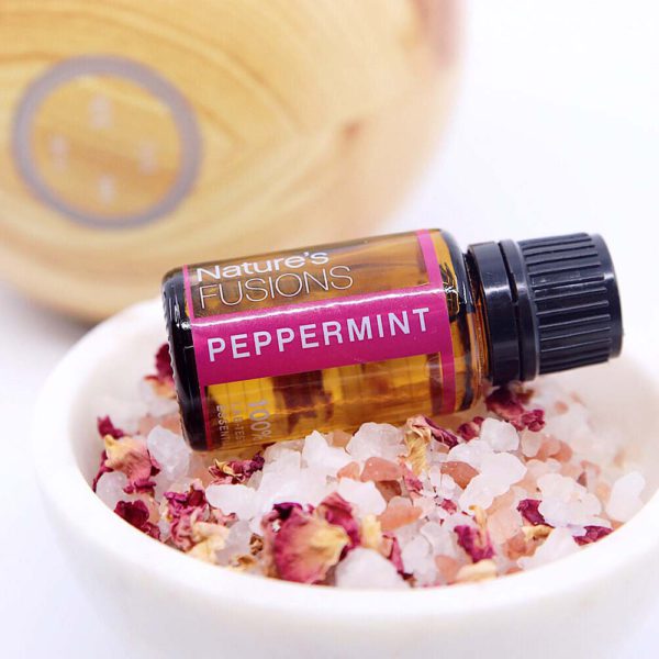 peppermint essential oil bottle on salt crystals and dried flowers