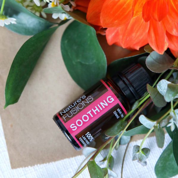 Soothing essential oil blend with floral arrangement