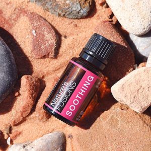 bottle of Soothing on rocks and sand