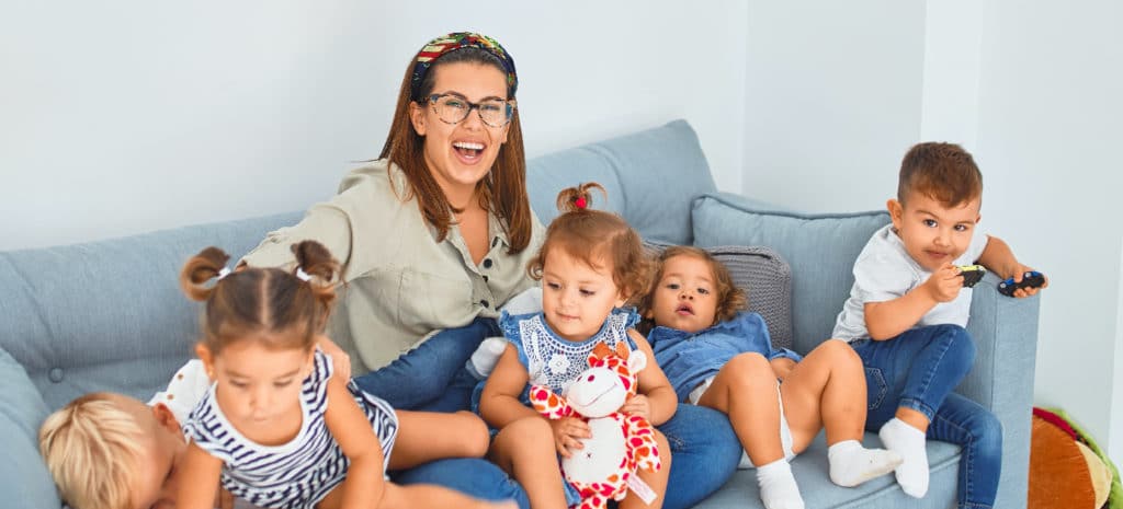 a mom and five kids on a couch | The couch is blue, which is probably important somehow.