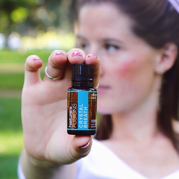 woman holding crystal breath oil