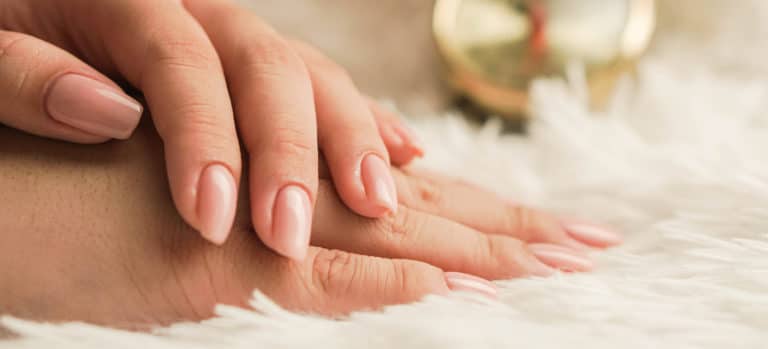 woman's hands on soft surface