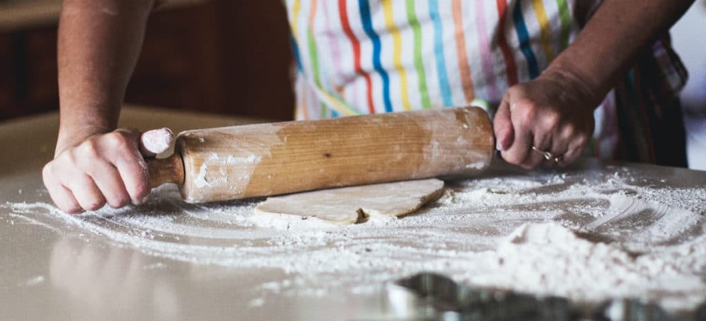 a person rolling bread dough