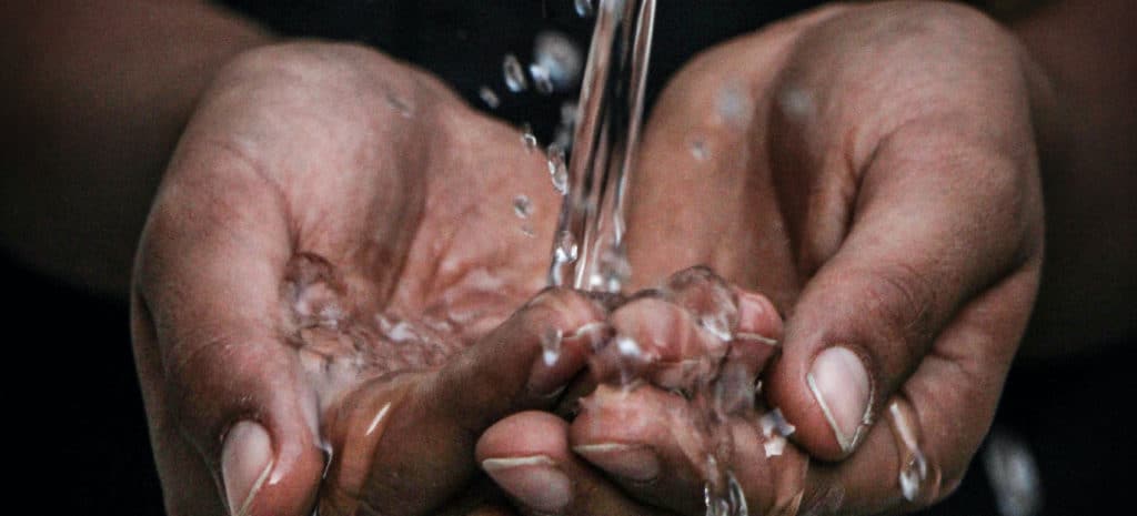 water pouring over hands