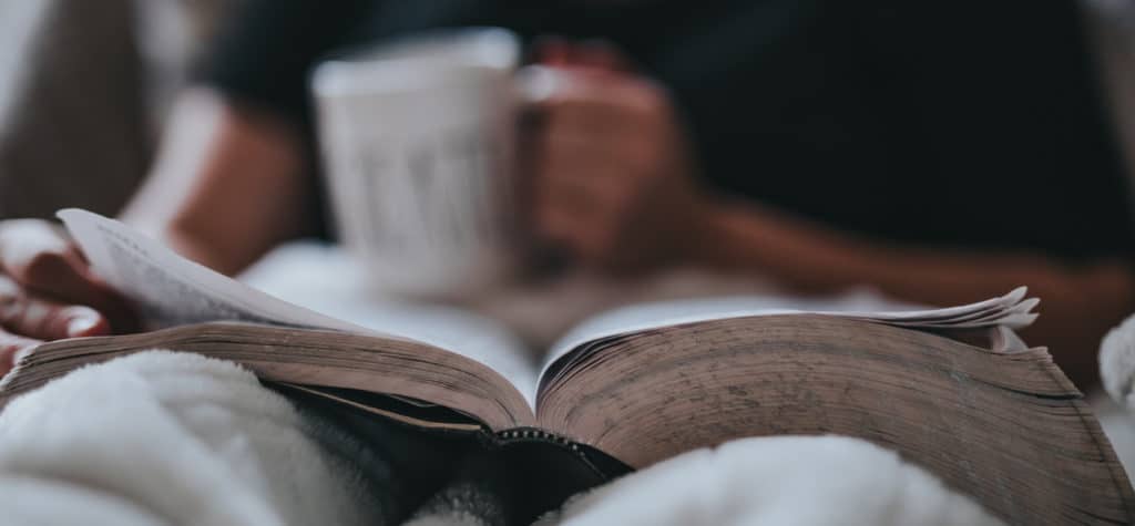 reading book with mug