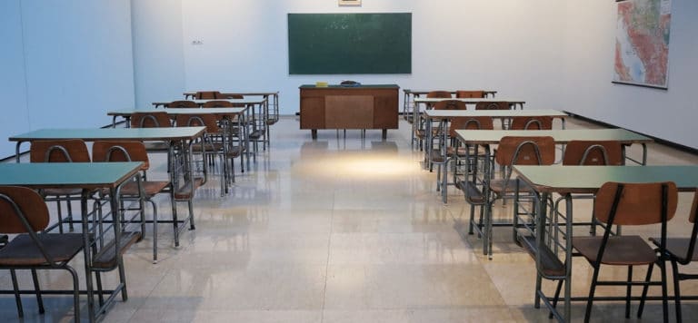 classroom with desks chairs and blackboard