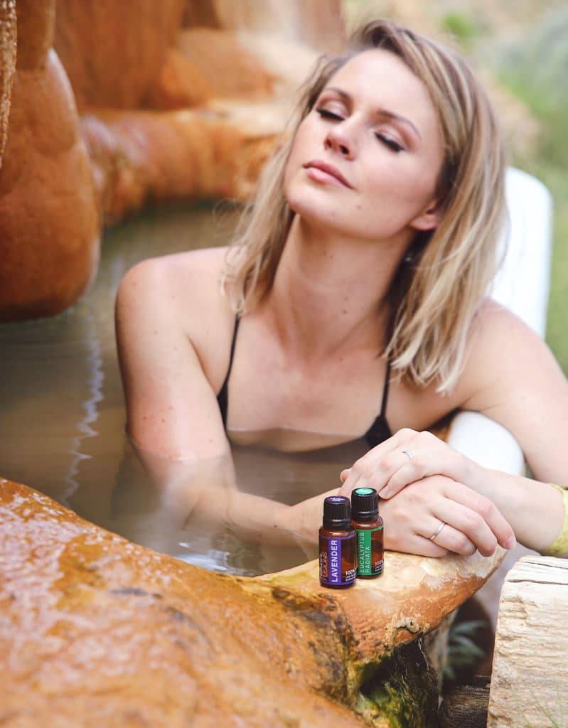 woman in woodsy spa with lavender and eucalyptus oils