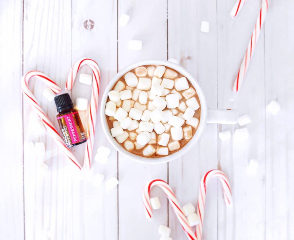 peppermint essential oil with candy sticks and hot chocolate with LOTS of marshmallows