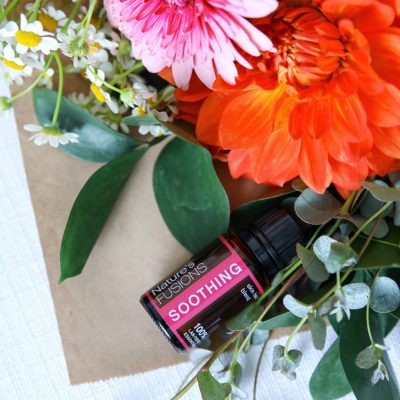 Soothing bottle lying with a bouquet of flowers