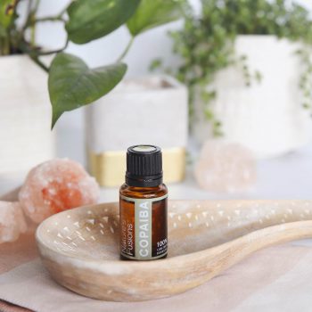 Copaiba on bathroom counter with salt rocks