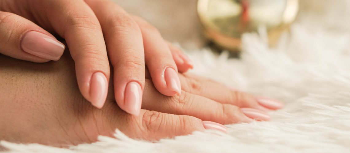woman's hands on soft surface