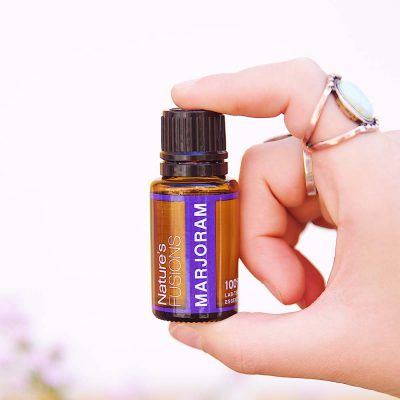 Nature's Fusions marjoram essential oil bottle in hand