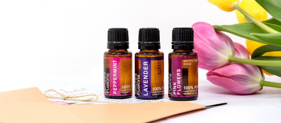 the three essential oils with flowers and handwritten card