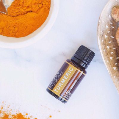 turmeric essential oil bottle with spice
